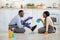 Cheerful black couple chatting to each other on kitchen floor after domestic cleanup, full length portrait