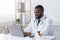 Cheerful black doctor checking on new pills online