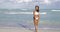 Cheerful black girl walking on beach