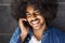 Cheerful black guy using cell phone