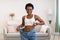 Cheerful Black Woman Wearing Huge Jeans After Slimming At Home