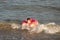 A cheerful boy 5 years old swims in the sea on an inflatable ring in the form of a donut on a sunny day