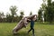 Cheerful boy running with a flying blanket in the park