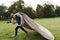 Cheerful boy running with a flying blanket in the park