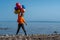 Cheerful boy standing with balloons on lake shore