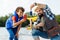 Cheerful boy taking picture of fish while fishing with dad