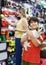 Cheerful boy tweenager with havanese pup while family shopping with mother