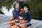 Cheerful boys sitting with pumpkins and apples