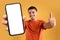 Cheerful brazilian man holding huge phone with white screen