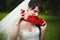 Cheerful bride bites the wooden letters of red