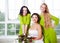 Cheerful bride with bridesmaid holding bouquet