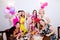 Cheerful bride and bridesmaids celebrating hen party with drinks