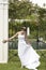 Cheerful Bride Standing At The Entrance Of Garden