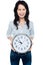 Cheerful brunette in casual presenting a wall clock