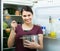 Cheerful brunette dusting inl kitchen