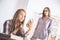 Cheerful businessladies applying makeup