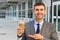 Cheerful businessman showing his coffee