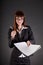 Cheerful businesswoman with documents and pen