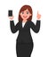 Cheerful businesswoman showing blank screen mobile, cell or smart phone and gesturing hand pointing finger up. Mobile phone.