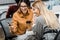 Cheerful businesswomen using smartphone at workplace