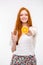 Cheerful candid redhead girl holding glass and offering orange