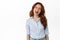 Cheerful candid redhead girl, smiling and showing tongue, winking at you carefree, standing relaxed and joyful against