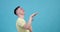 Cheerful caucasian man dancing on a blue background