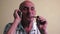 Cheerful Caucasian pensioner over 70 years old smokes a pipe and communicates on a mobile phone. Elderly man with a smartphone. Se