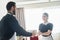 cheerful chambermaid giving towels to blurred