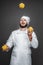 Cheerful chef juggling with ripe peppers