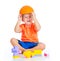 Cheerful child boy with hard hat plays with building blocks toys