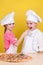 Cheerful children cook pizza