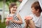 Cheerful children eating watermelon in a camp