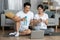 Cheerful chinese man and woman drinking water after workout