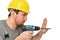 Cheerful construction worker - craftsman in working clothes with a drilling machine on white background - insulated