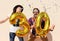 Cheerful couple celebrates a thirty years birthday with big golden balloons