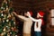 Cheerful couple decorates a Christmas tree in country house