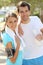 Cheerful couple drinking water after jogging