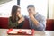 Cheerful Couple in eating burgers fast food Reastaurant