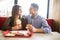 Cheerful Couple in eating burgers fast food Reastaurant