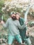 Cheerful couple of farmers standing in vegetable garden. Eco living. A pair of farms working in the garden. Fresh