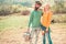 Cheerful couple of farmers standing in vegetable garden. Young Couple gardening in the garden. Portrait of pair of farms