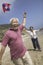 Cheerful Couple Flying Kite On Beach