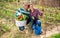 Cheerful couple of gardeners proud of harvest of vegetables