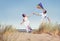 Cheerful Couple Playing Kite by the Beach