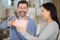 Cheerful couple poised to smash piggy bank