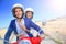 Cheerful couple riding moto in desertic island