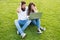 Cheerful couple use laptop sit green grass, shocking concent concept