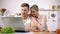 Cheerful couple watching cooking tutorials online, romantic dinner preparation