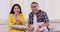 Cheerful couple watching sports game on TV